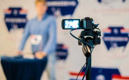 camera on focus filming a man in a blurry background